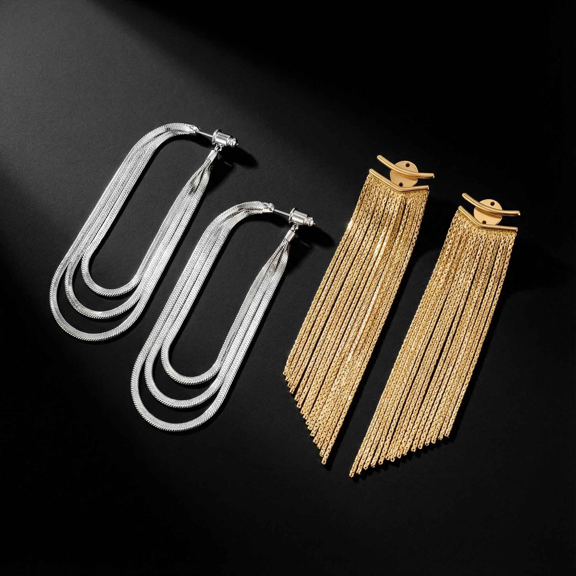 Two pairs of long fringe earrings, one silver and one gold, on a black background.