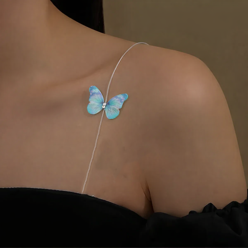 Blue butterfly strap on a person's shoulder against a brown background