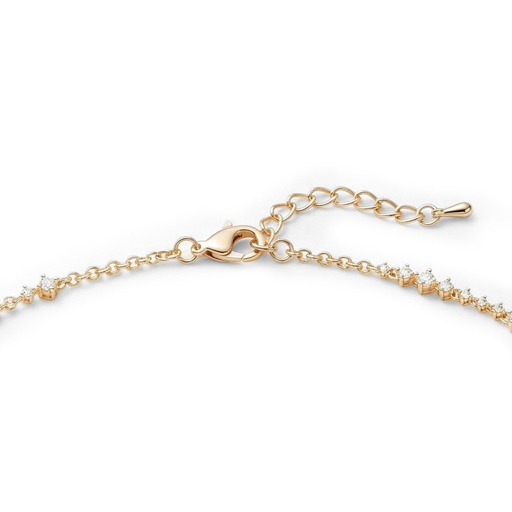 Gold necklace with small diamonds on a white background