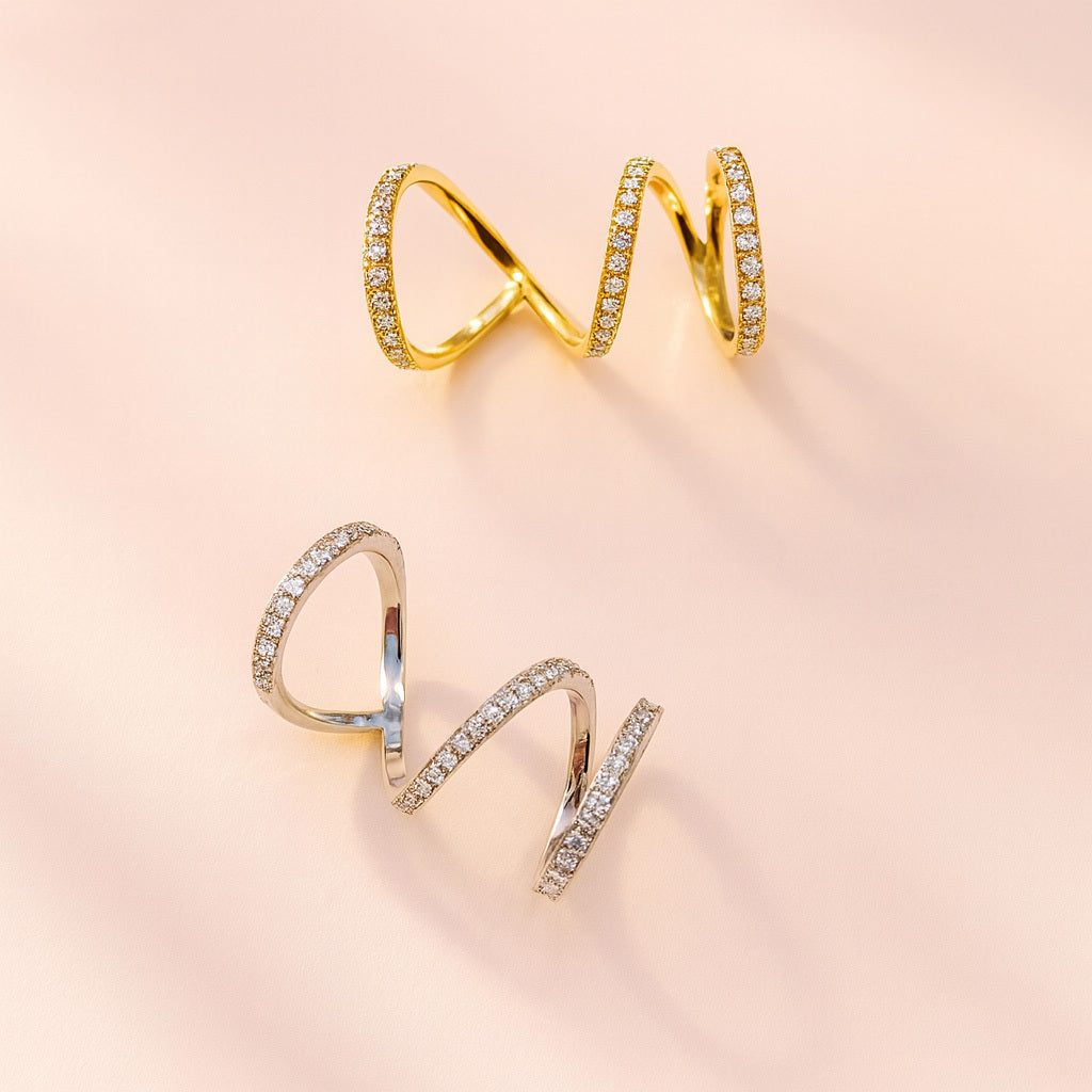 Gold and silver spiral rings with sparkling stones placed on a soft background, perfect for Christmas gifting, festive outfits, and holiday jewellery collections.