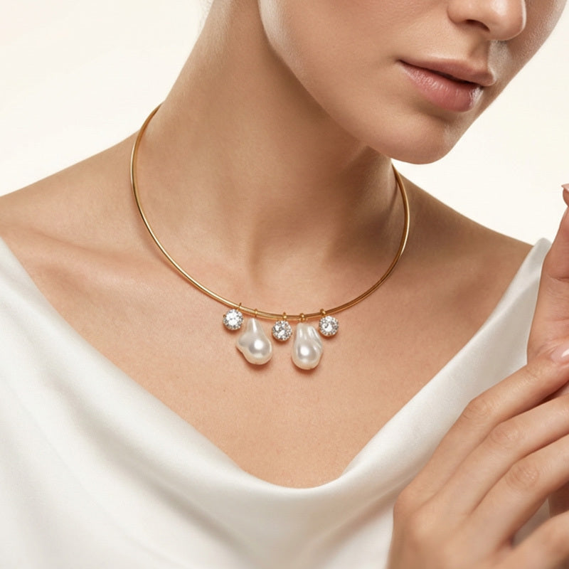 Gold necklace with pearls and crystals worn by a person