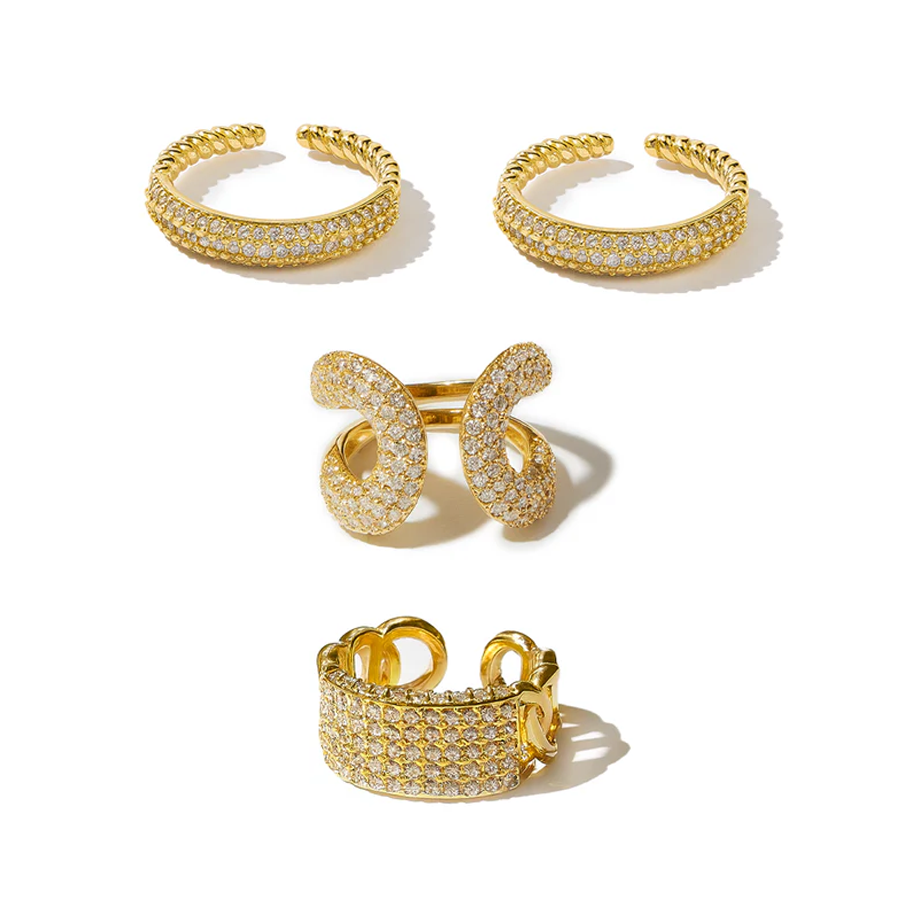 Set of gold rings with clear stones on a white background