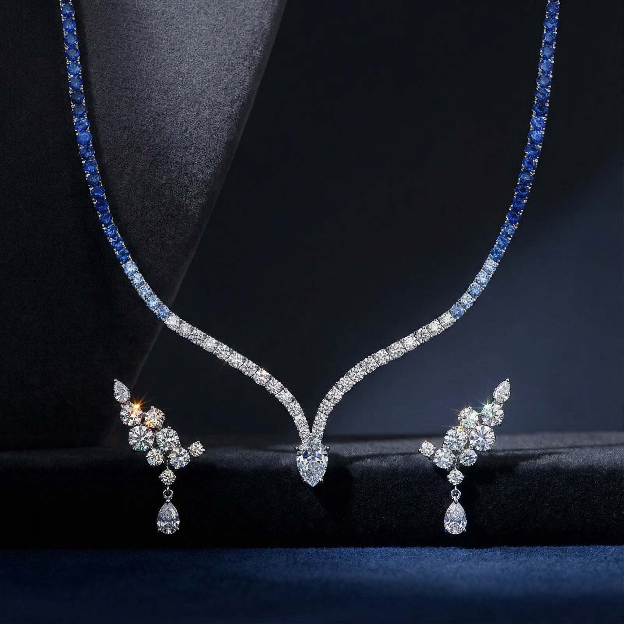 Diamond necklace and earrings on a dark background