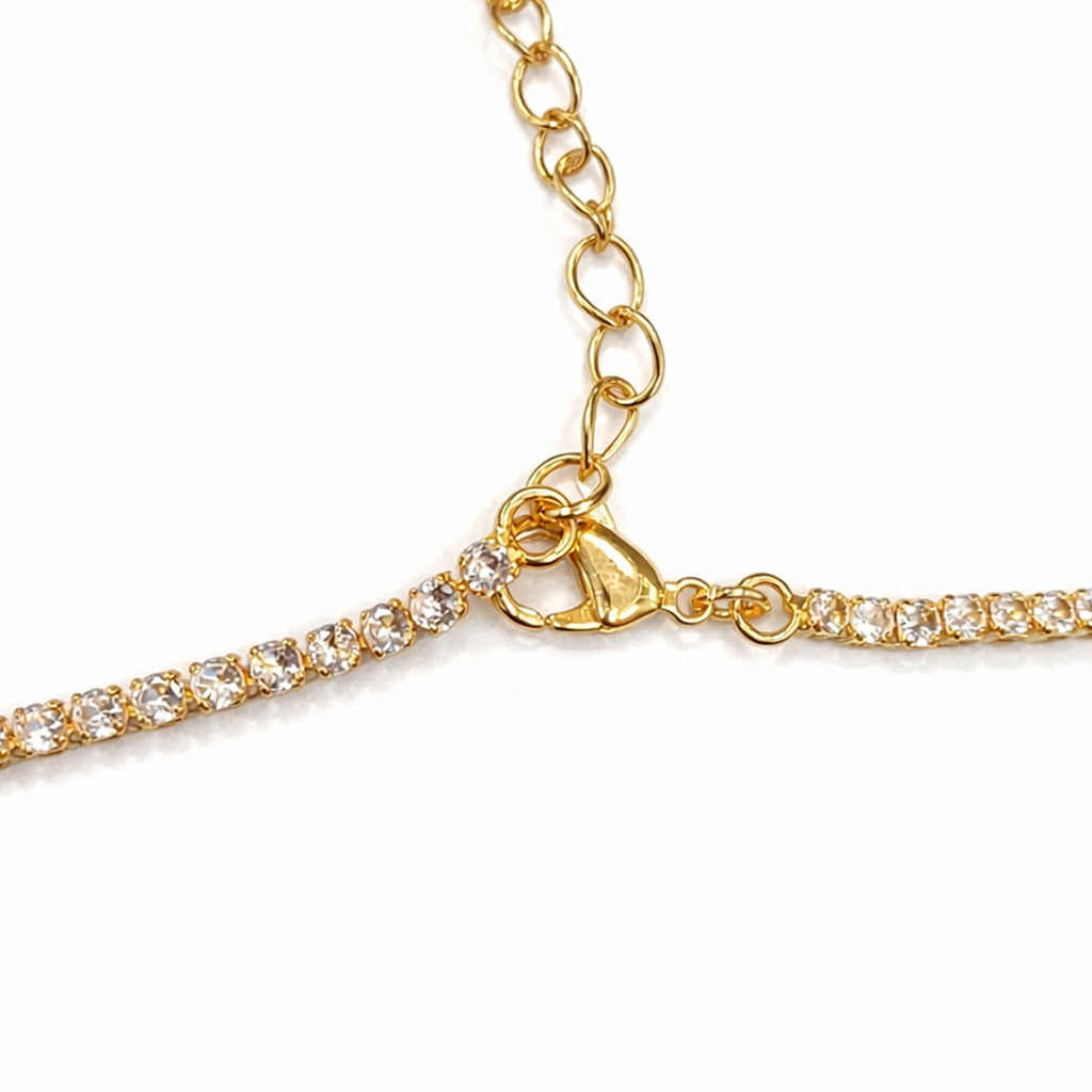 Gold necklaces for women with clear gemstones on a white background