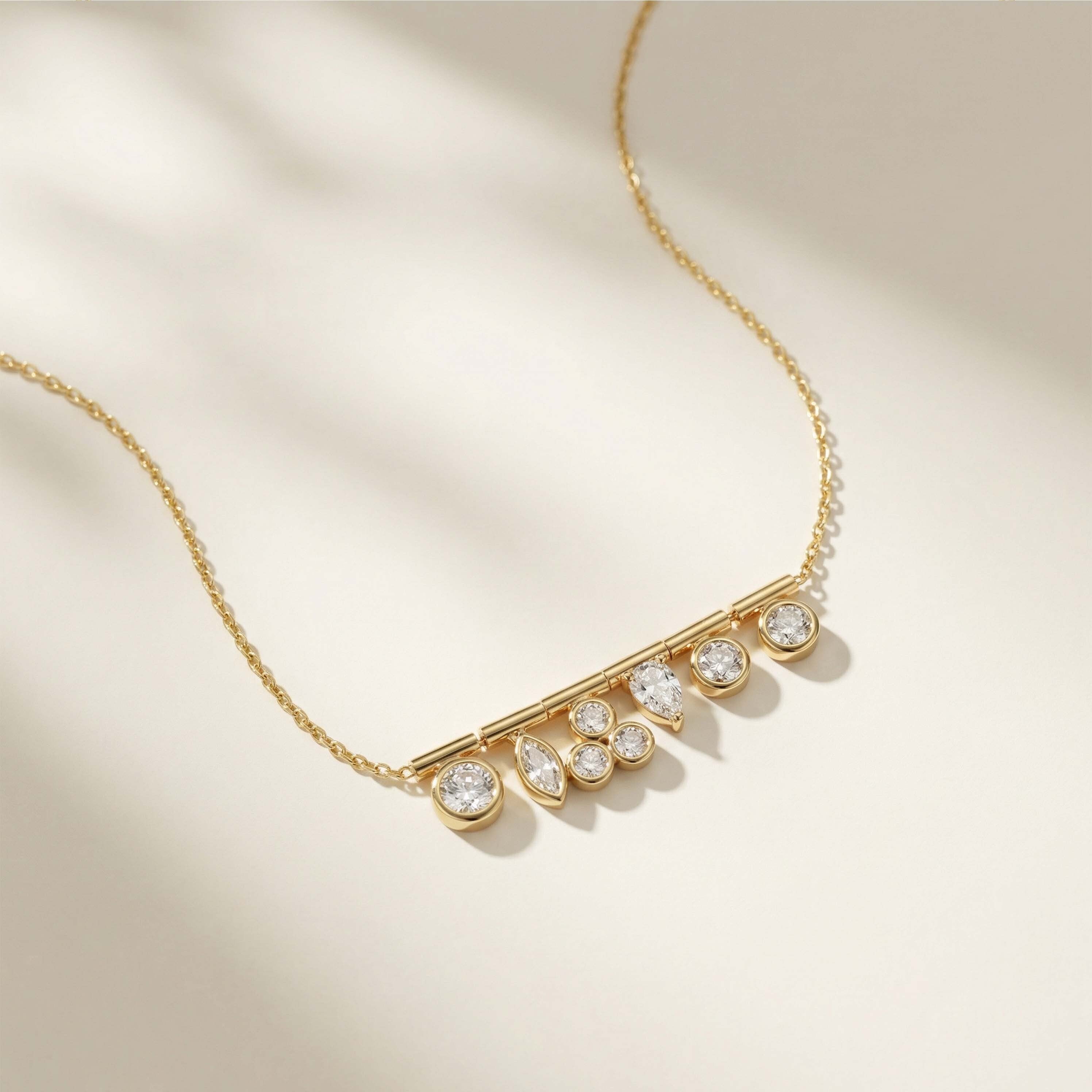 Gold necklace with clear stones on a beige background