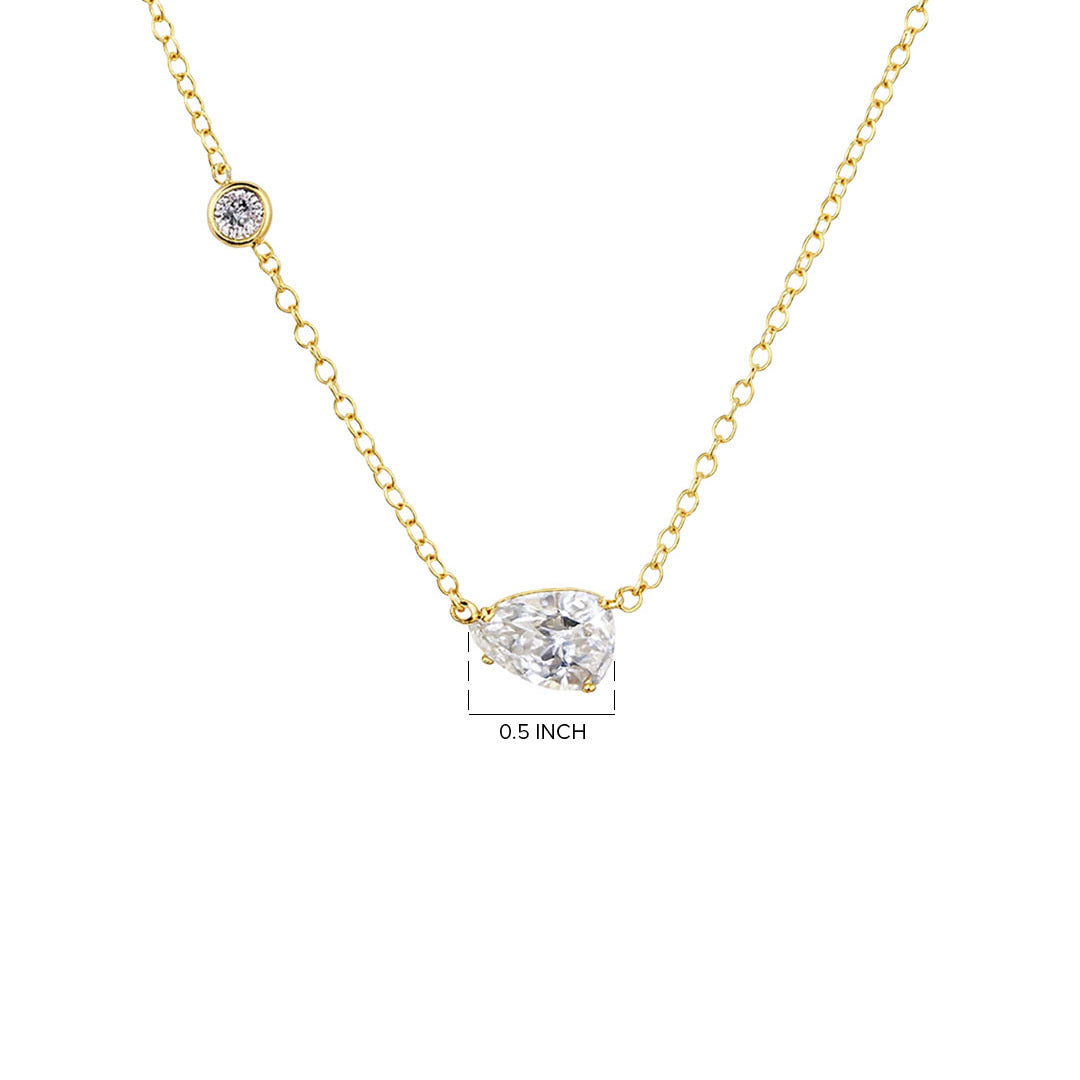 Gold necklace with a clear gemstone pendant on a white background