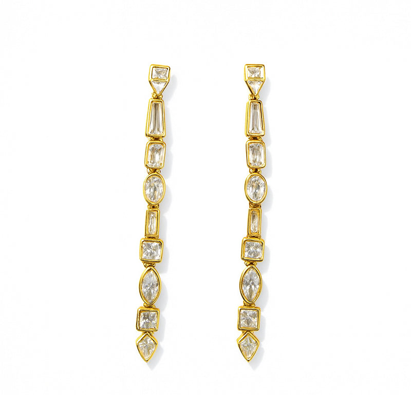 Gold and crystal drop earrings on a white background