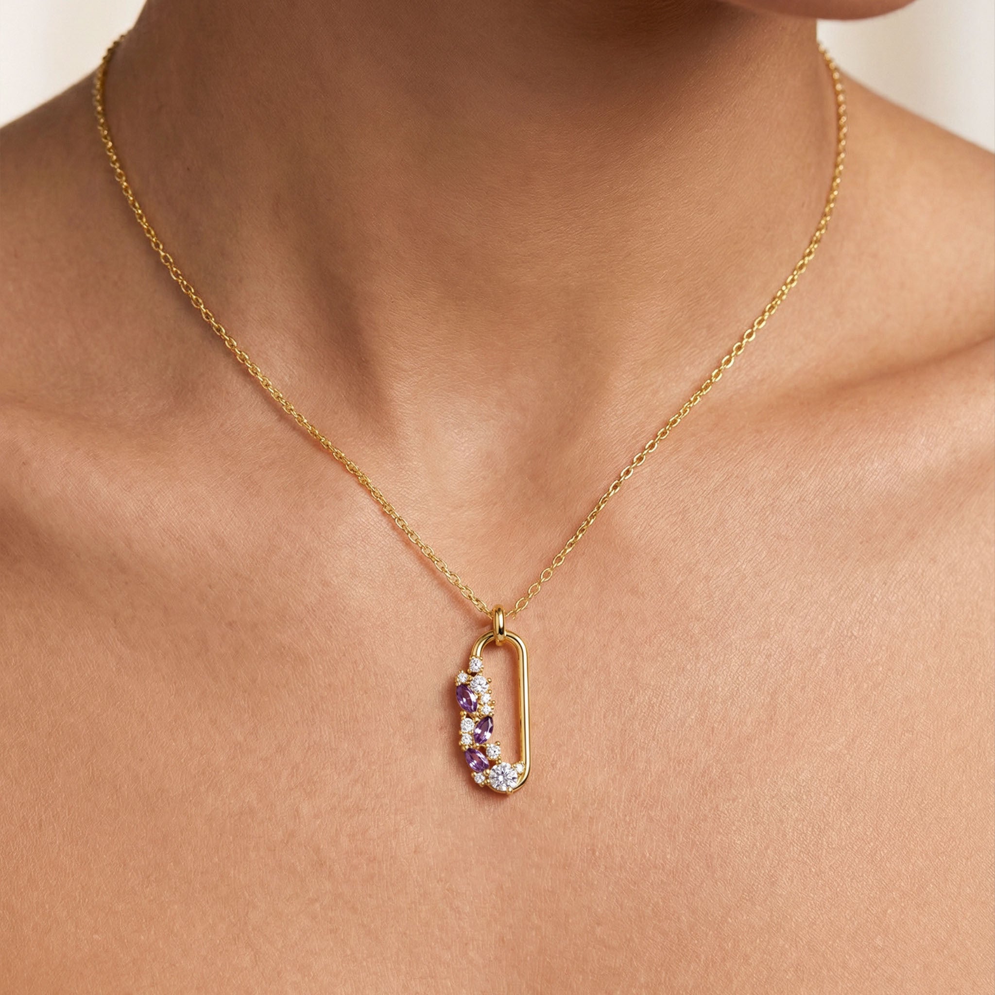Gold necklace with a colorful pendant on a person's neck