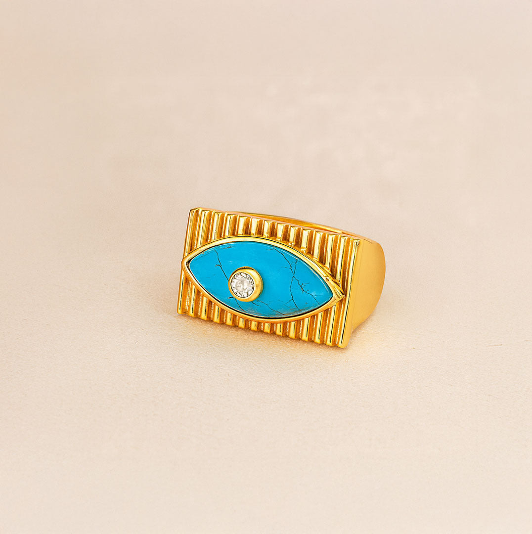 Gold ring with a blue eye design