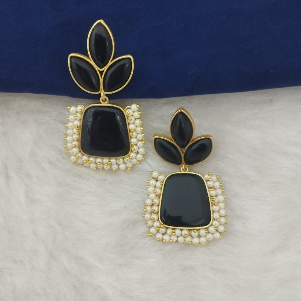 Black and gold earrings with pearl accents on a white surface