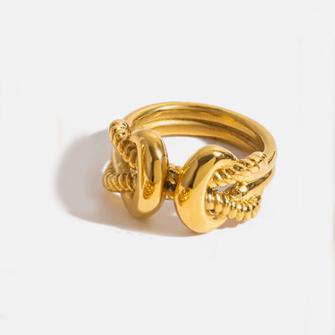 Gold knot ring on a white background