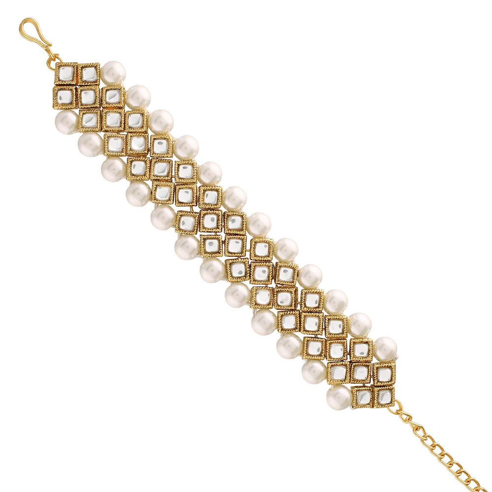 Gold bracelet with pearls on a white background