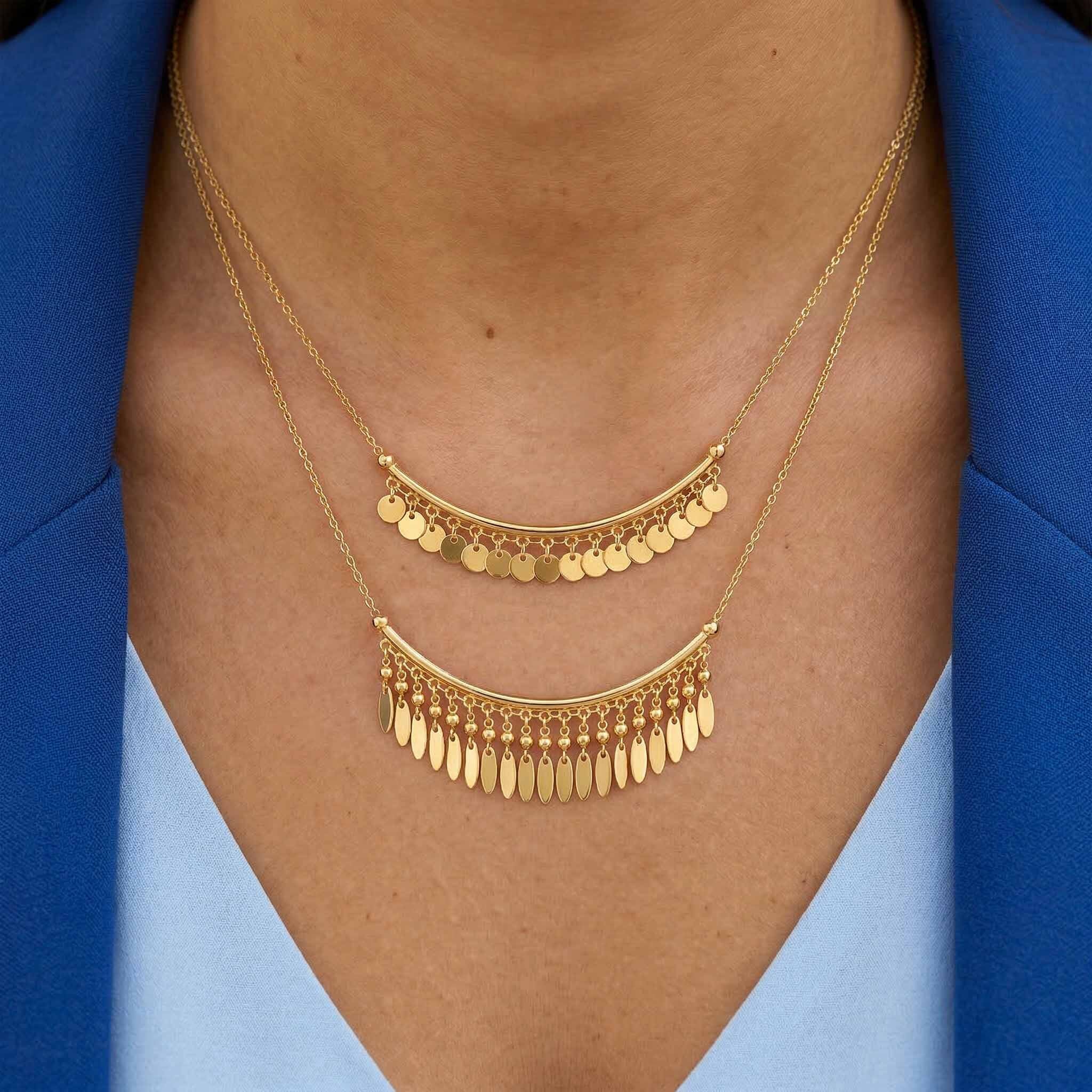 Elegant layered gold necklace for women featuring mini disc charms and dangling fringe details