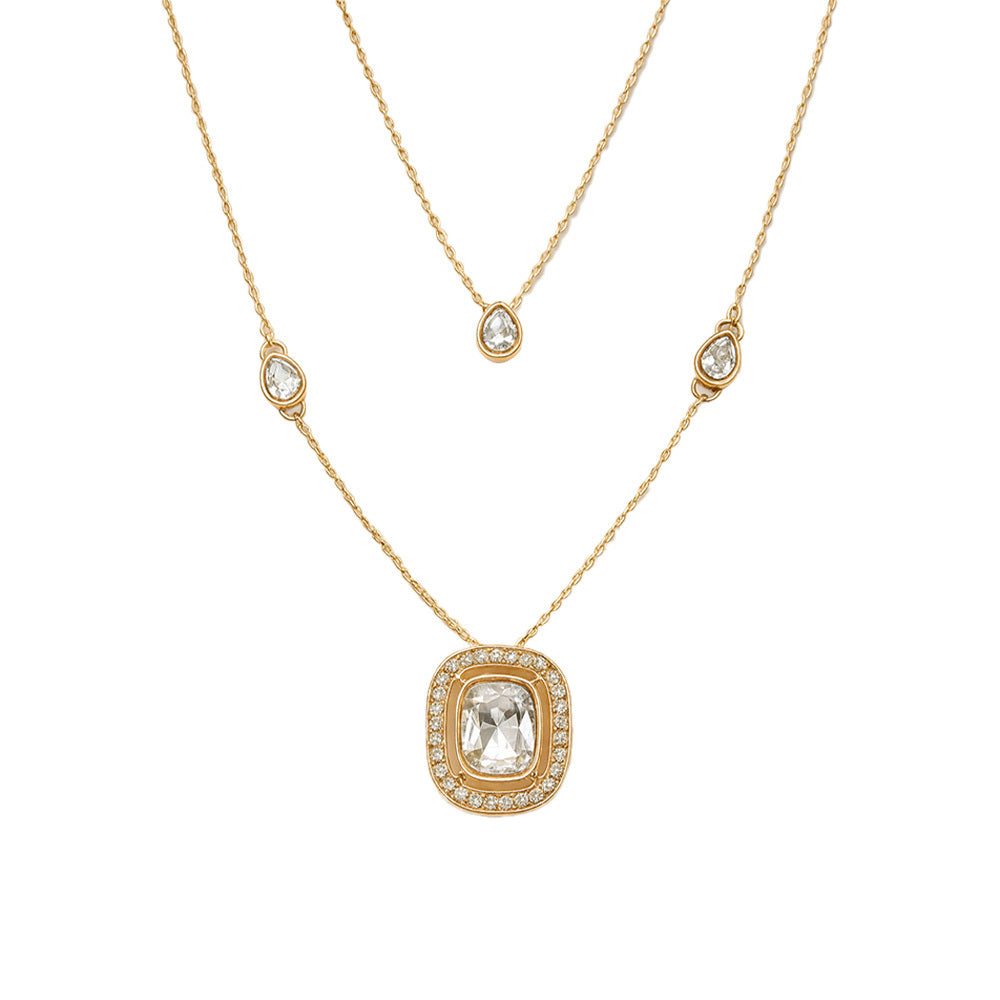 Gold necklace with a pendant and smaller beads