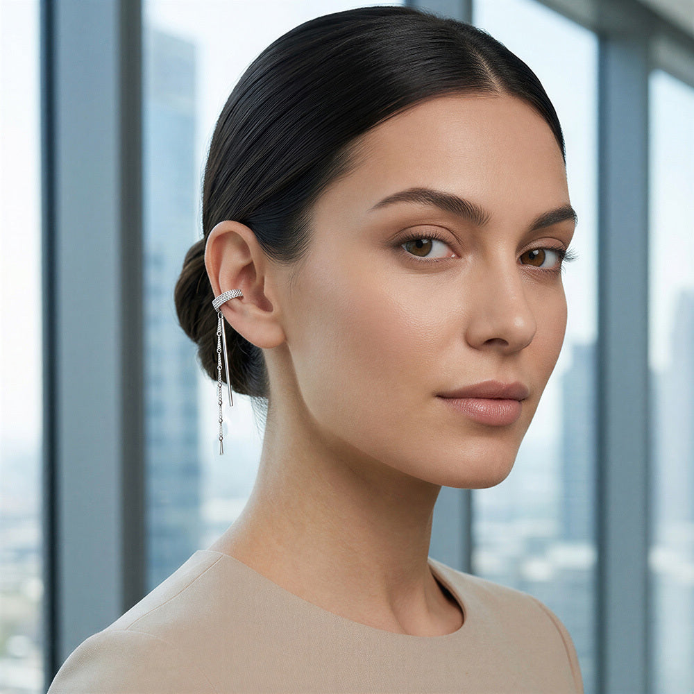 Woman wearing a silver earring with a blurred cityscape background