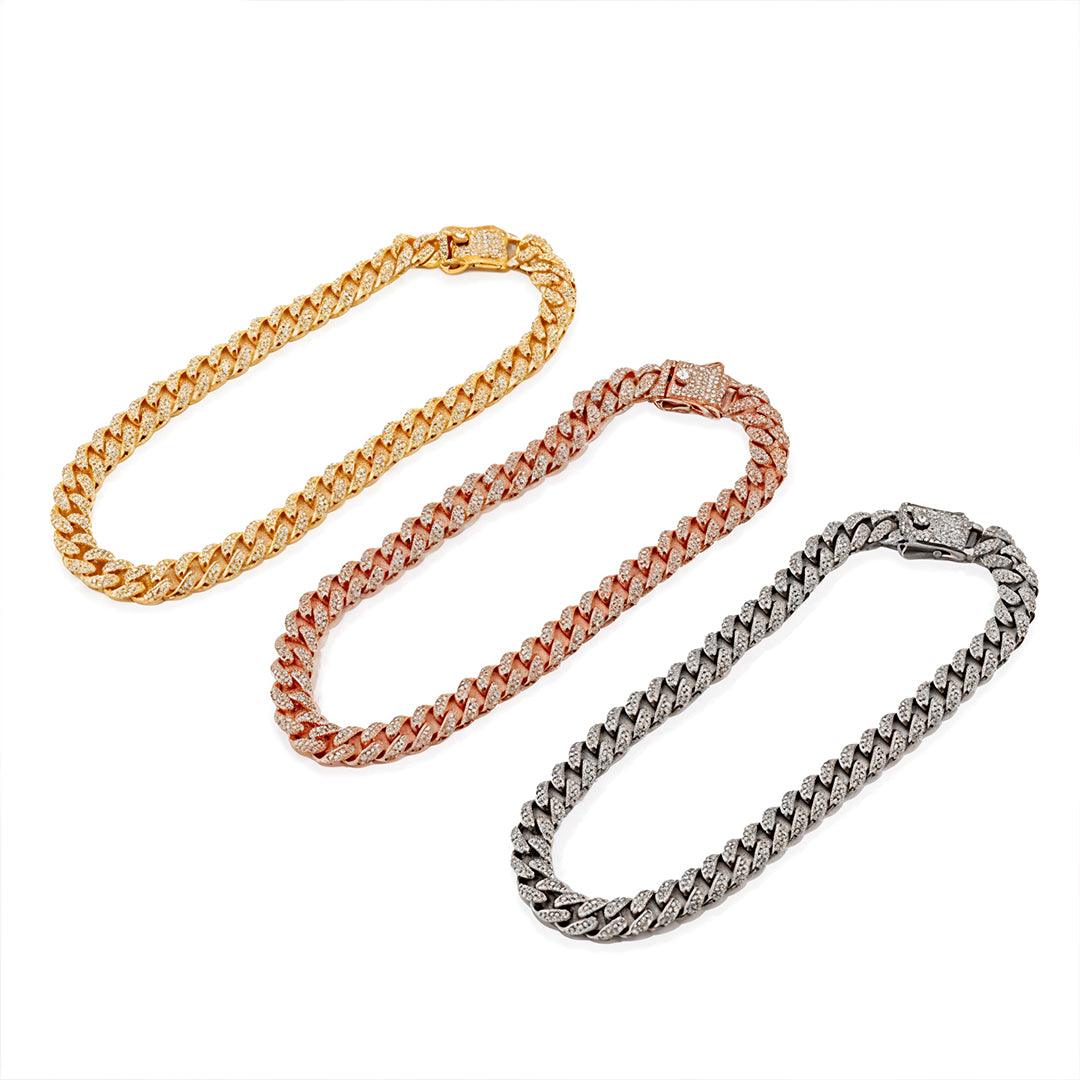 Three gold, rose gold, and silver chain necklaces on a white background