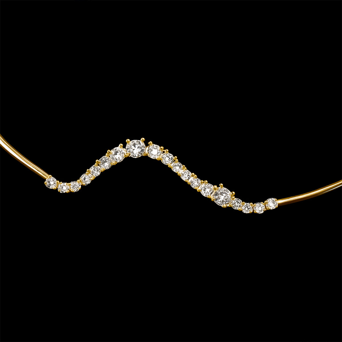 Gold necklace with a wavy design and embedded diamonds on a black background
