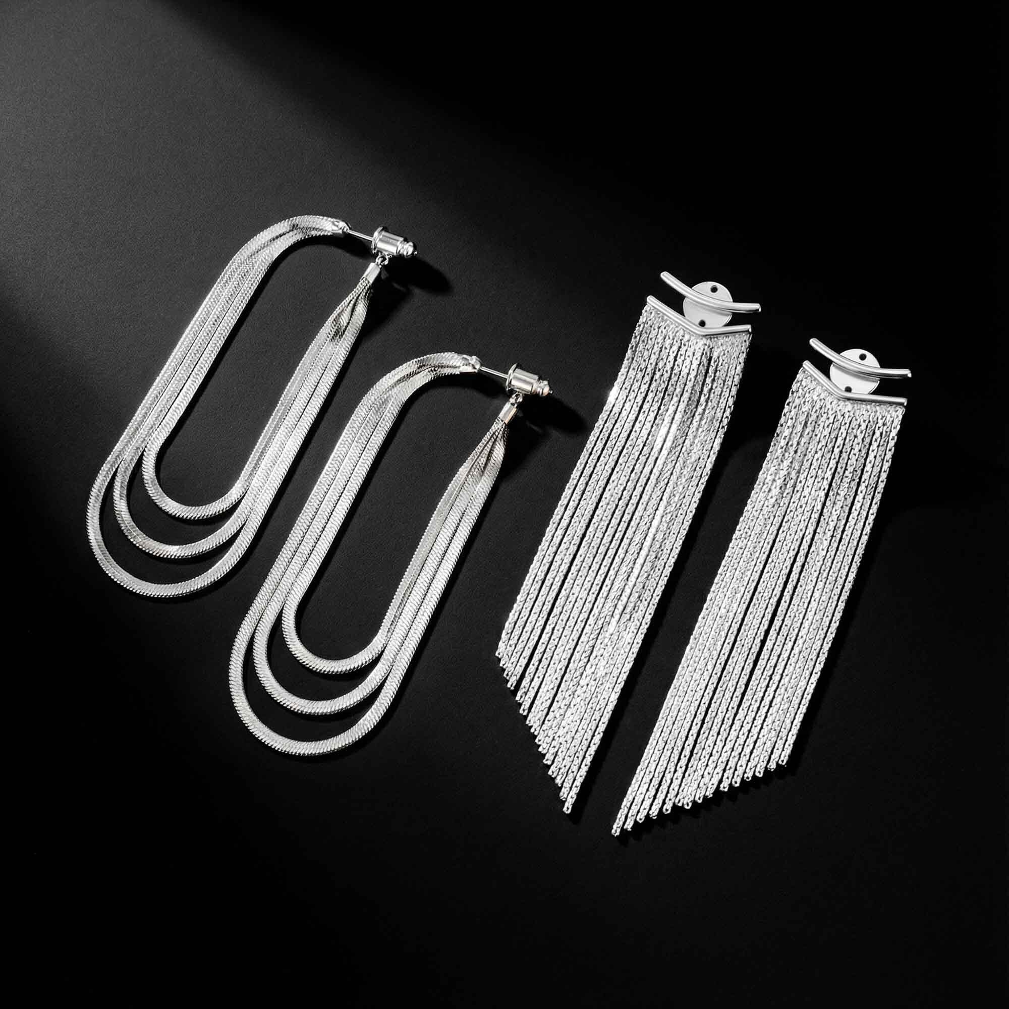 Pair of silver fringe earrings on a black background