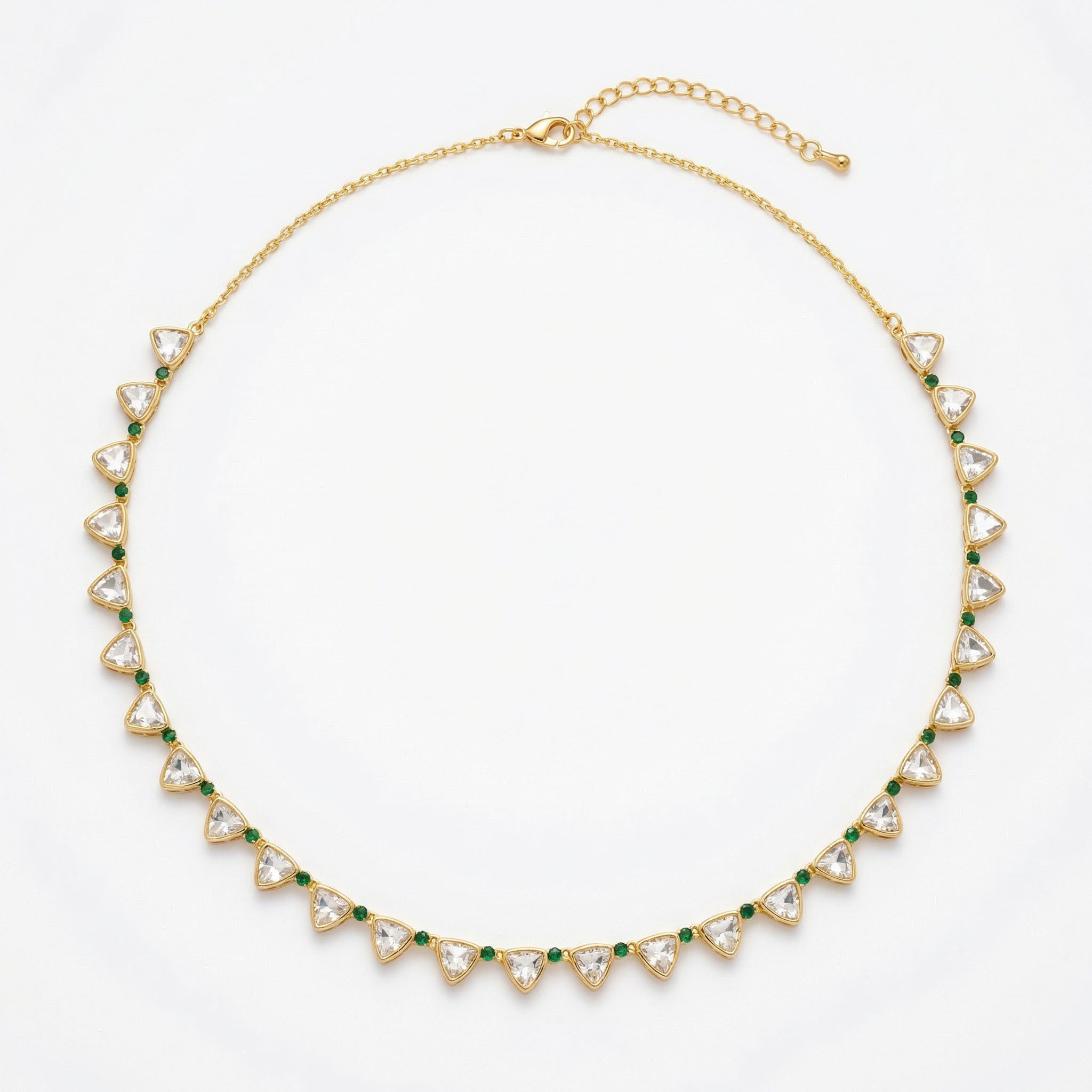 Gold necklace with triangular gemstones on a white background
