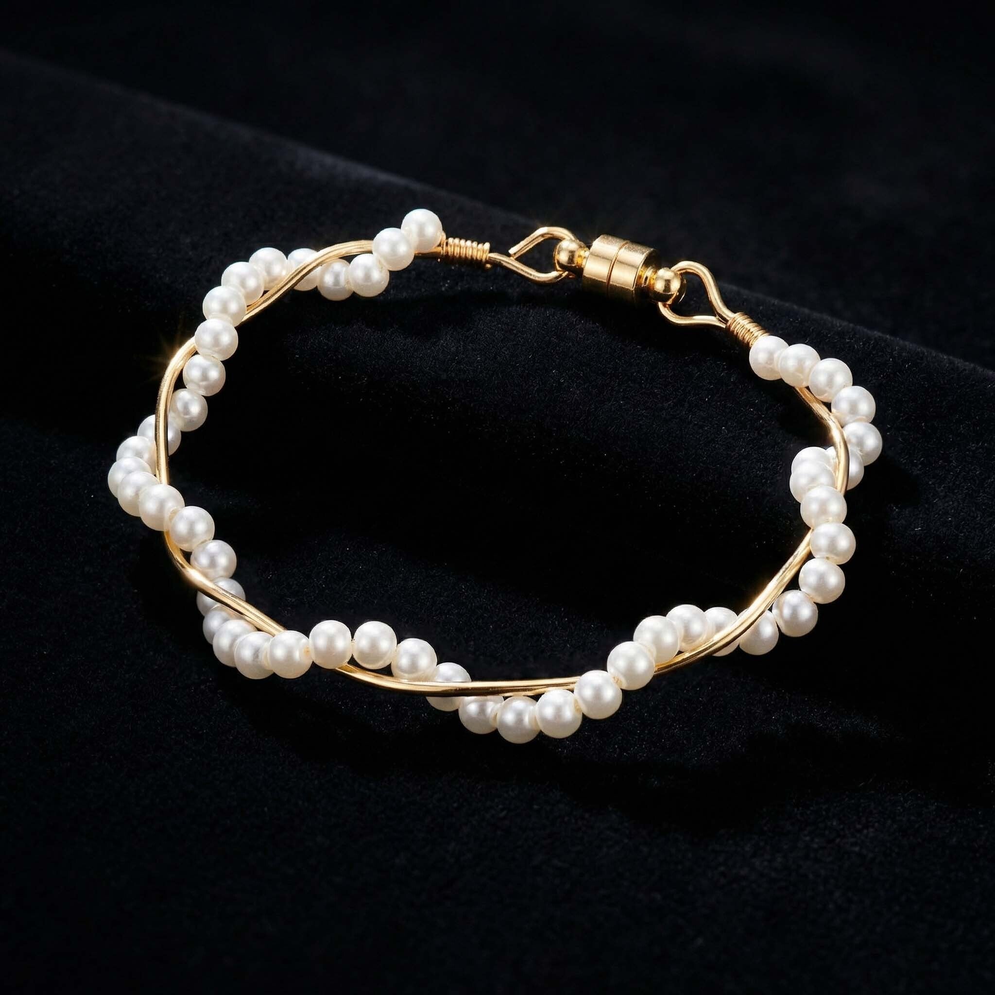 Pearl bracelet with gold wire on a black background