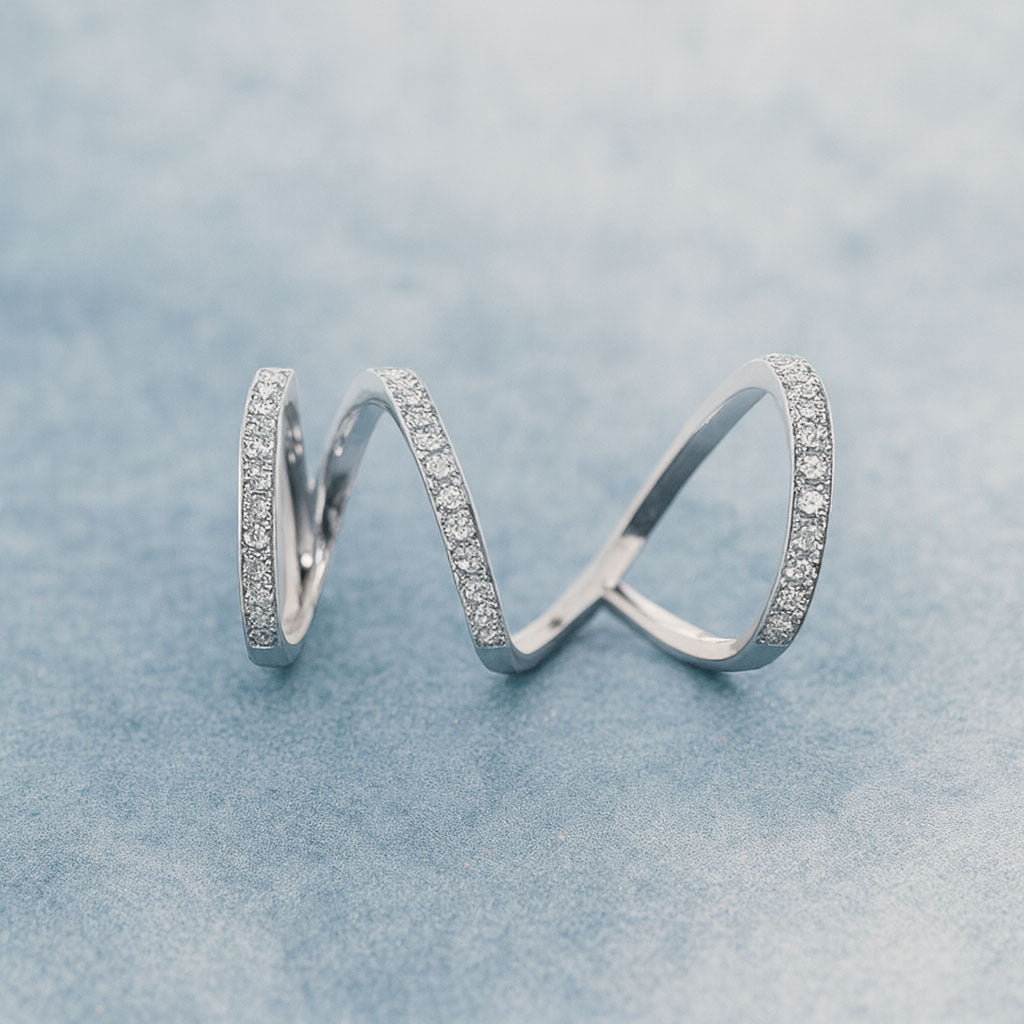 Silver rings with embedded stones on a light blue background