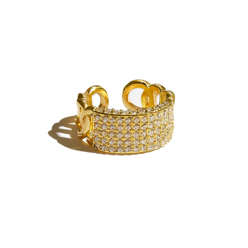 Gold ring with diamond accents on a white background