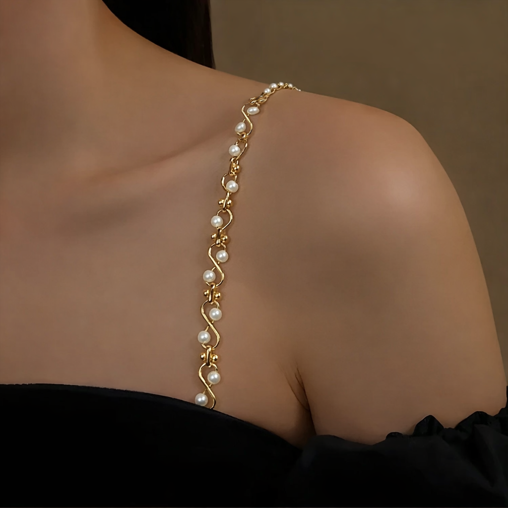Gold Stylish Shoulder Strap with pearls on a person's wrist against a neutral background