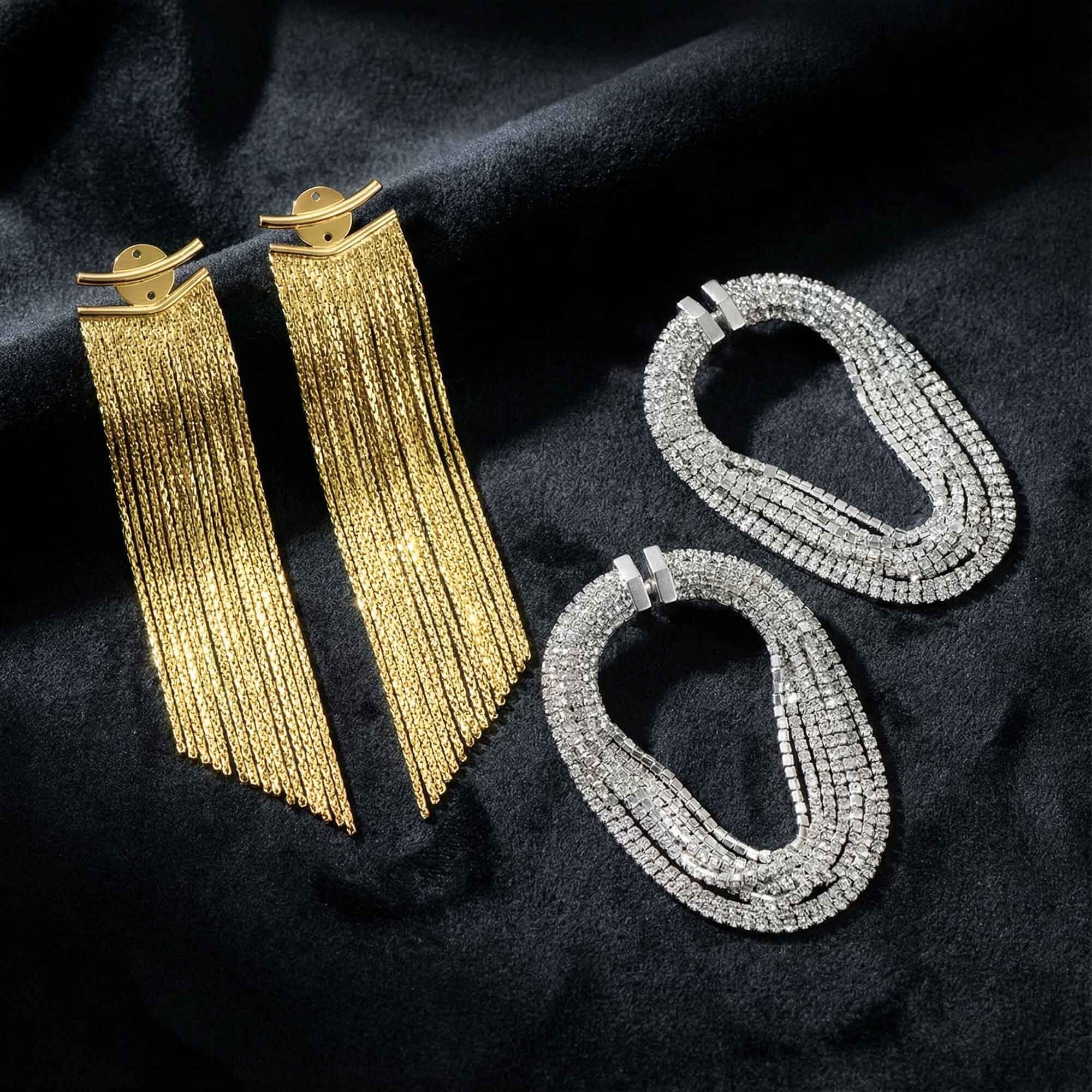 Gold and silver hoop earrings on a dark fabric background