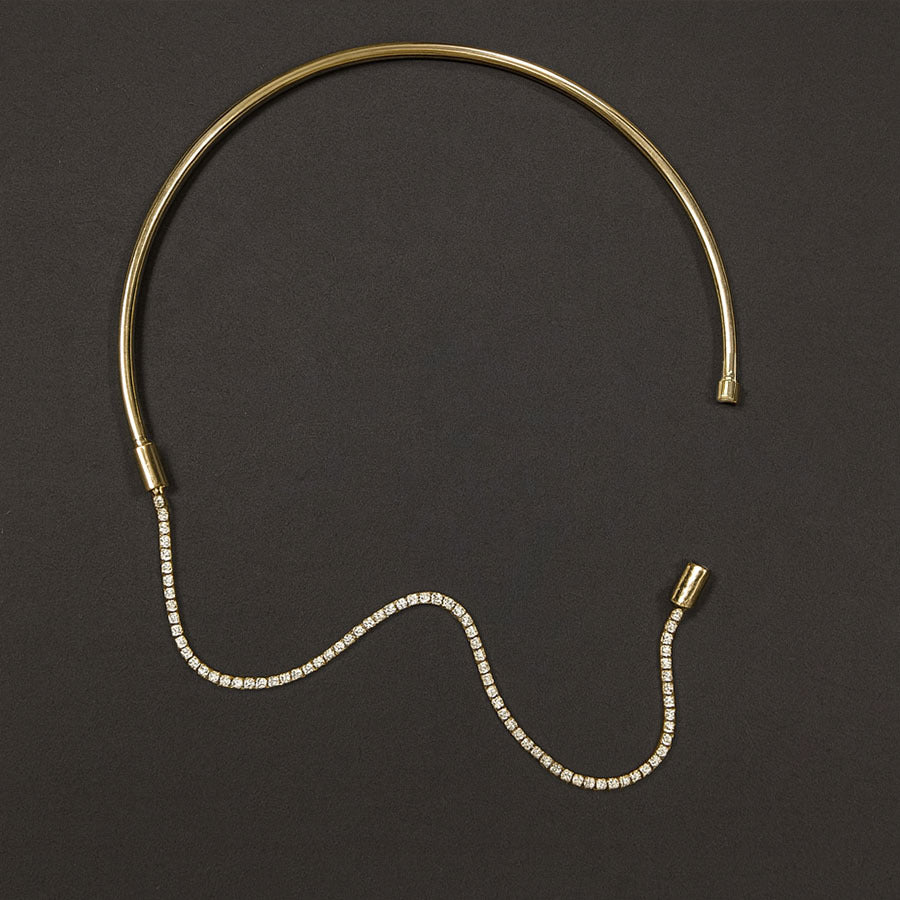 Gold and diamond headband on a dark background