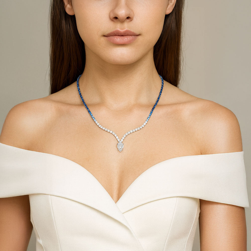 Woman wearing a necklace with a neutral background