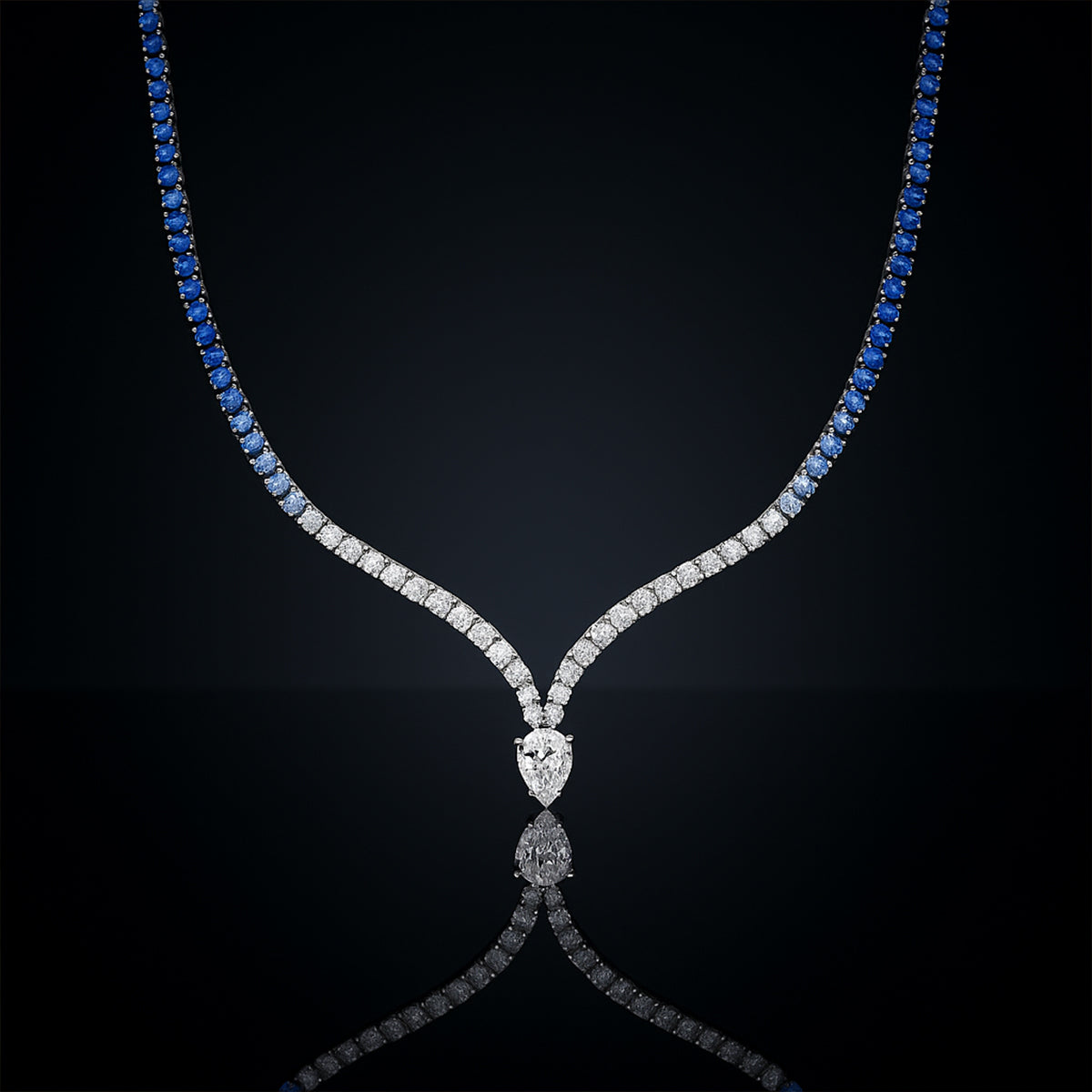 Diamond necklace with blue gemstones on a black background