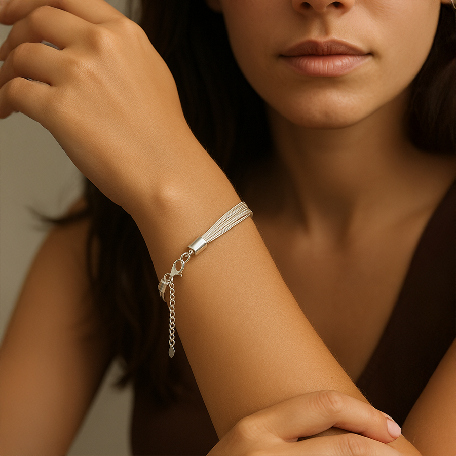 Close-up of a woman's arm wearing a silver bracelet with a blurred background