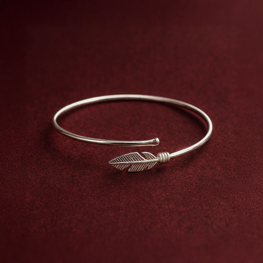 Silver bracelet with a feather charm