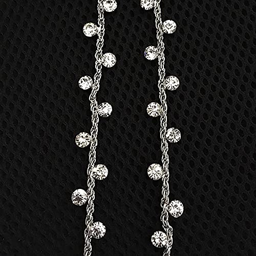Silver strap with clear stones on a black textured background