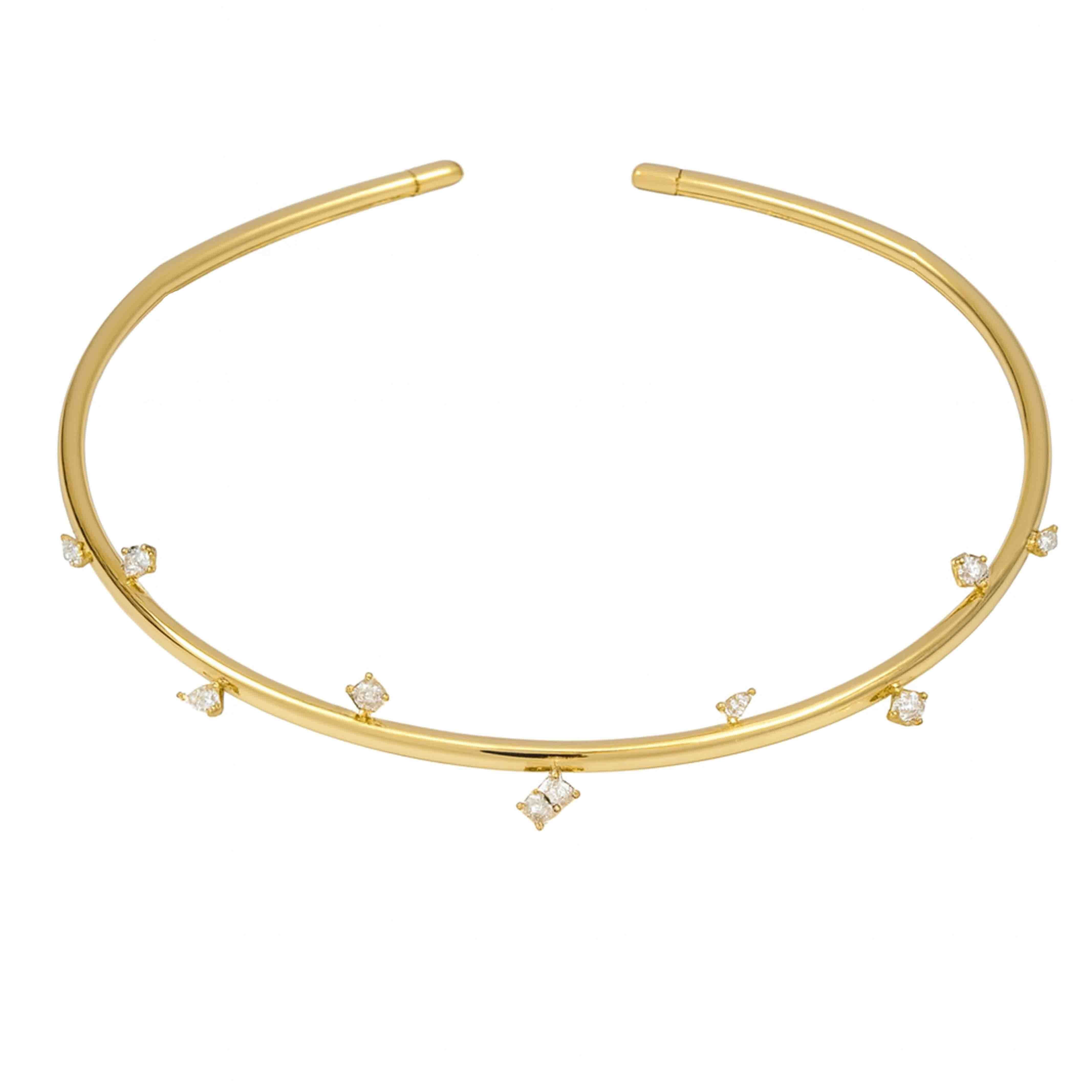 Gold choker necklace with small diamonds on a white background