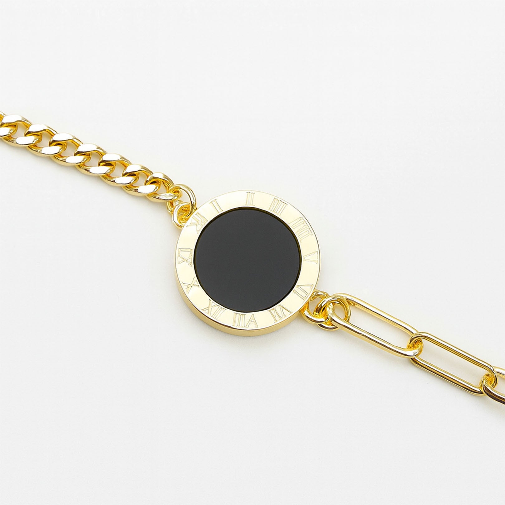 Gold chain bracelet with a black stone