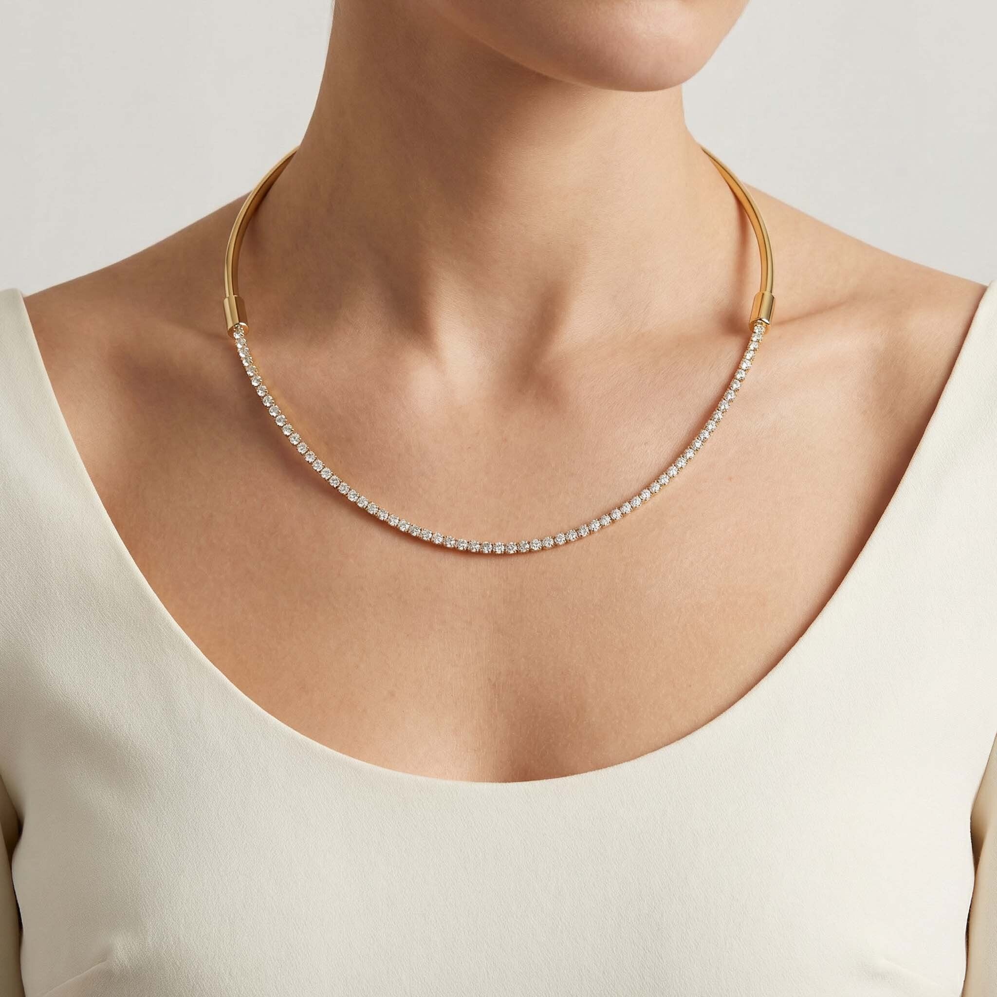 Gold necklace with small stones on a neutral background