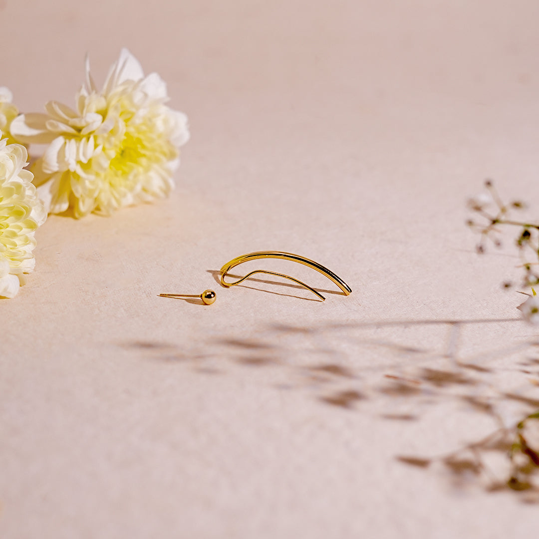 Gold stud earrings for women background with flower