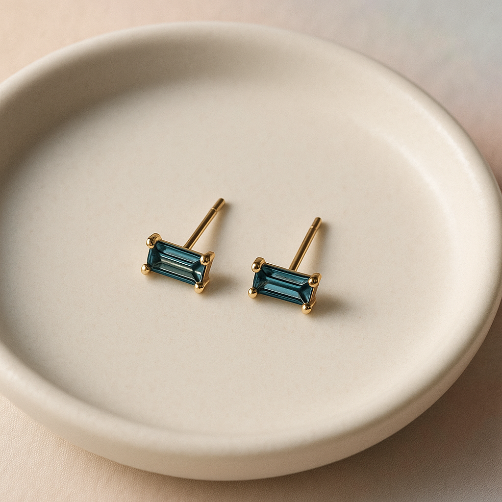 Pair of gold earrings with blue gemstones