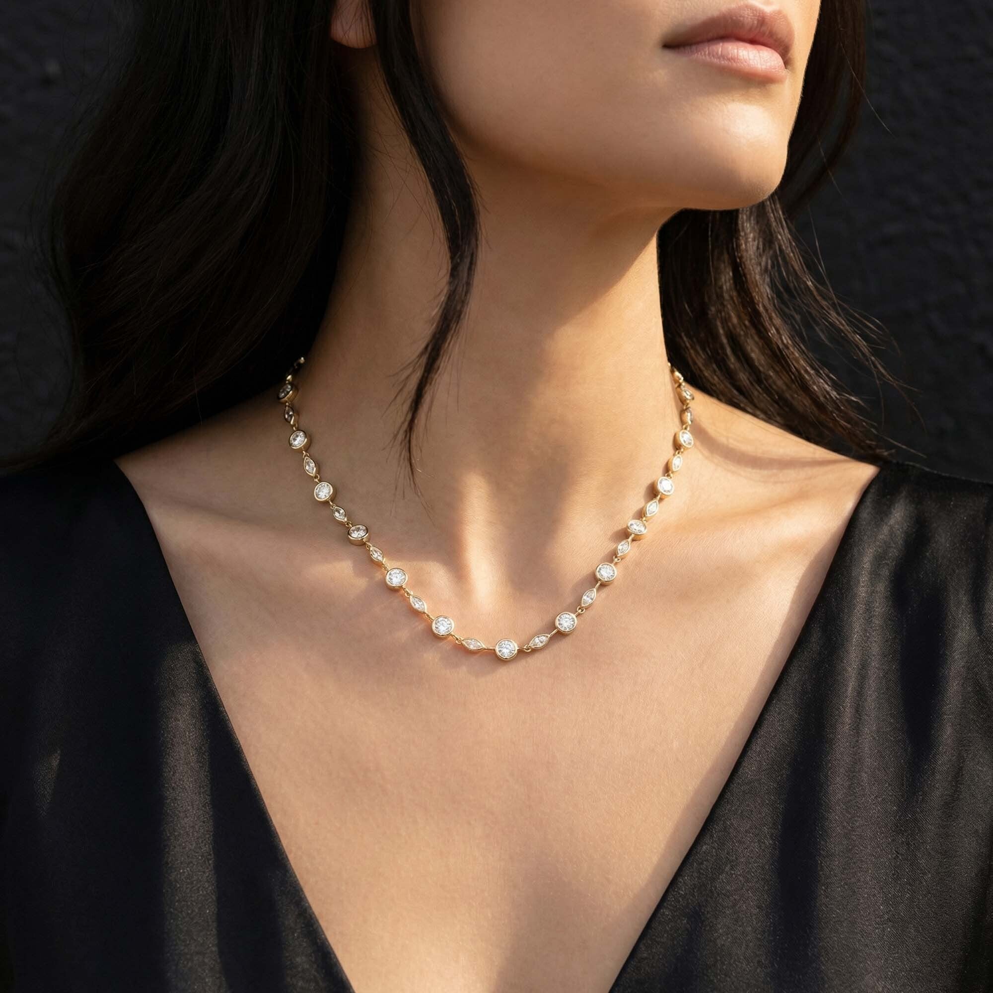 Pearl necklace worn by a model against a dark background