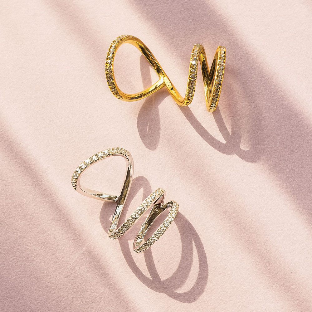 Gold rings on a pink fabric background