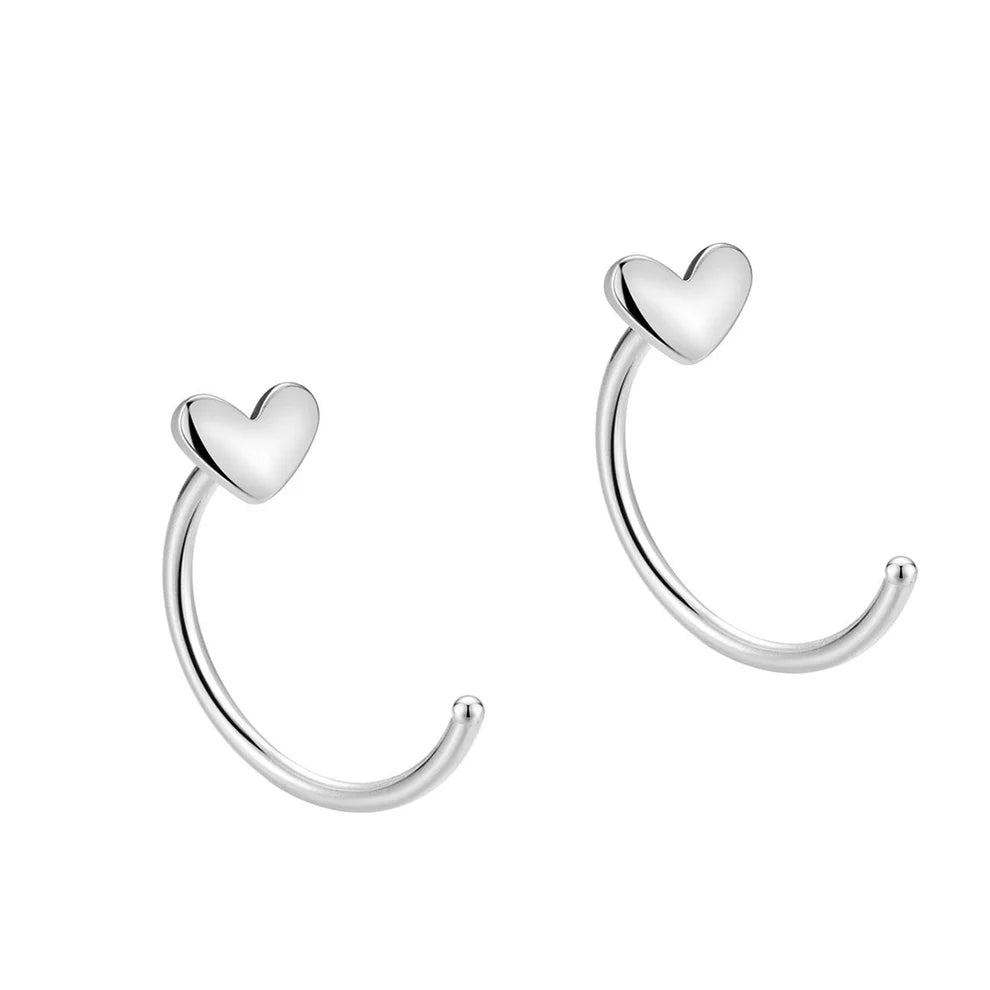 Pair of silver heart-shaped hoop earrings earrings for women on a white background