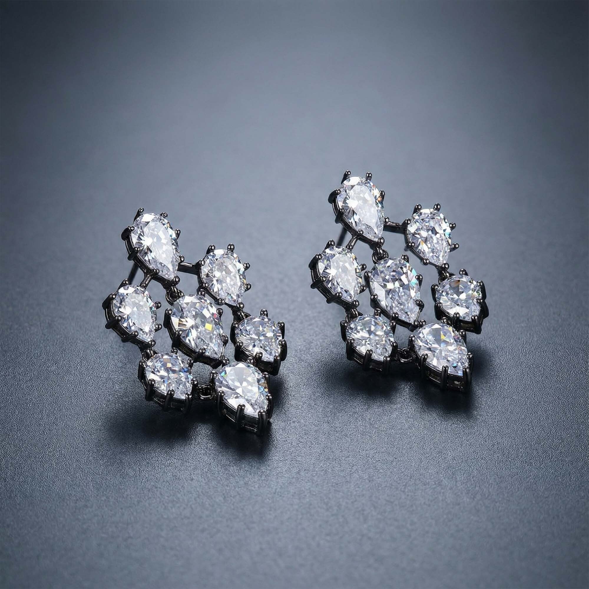 Pair of diamond earrings for women on a dark gray background