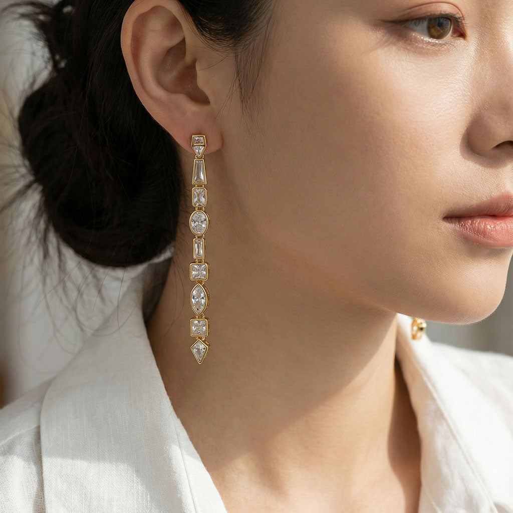 Close-up of a woman wearing a pair of diamond earrings with a blurred background