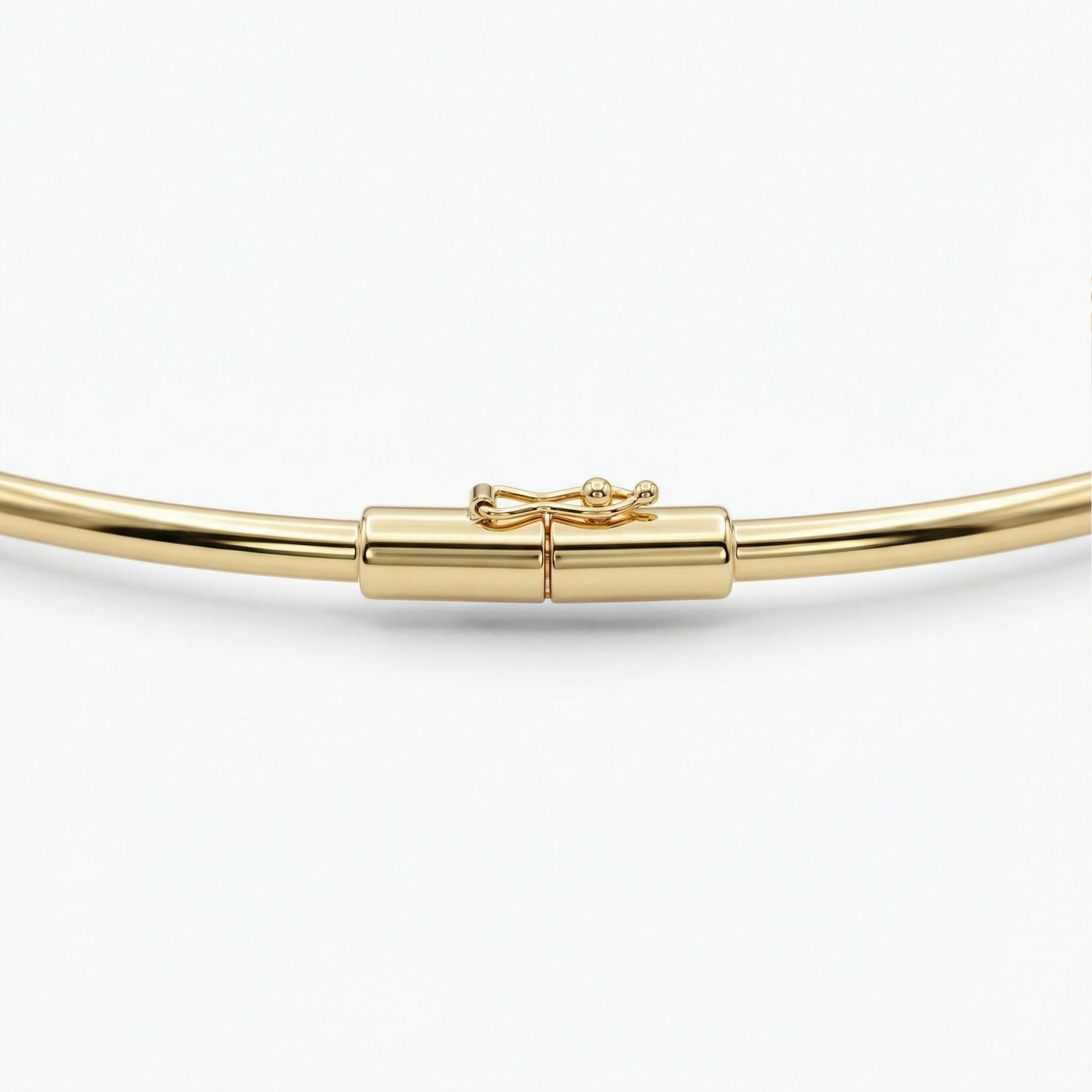 Gold neckalce with a bow clasp on a white background