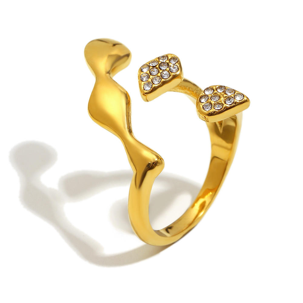 Gold ring with heart-shaped gemstones on a white background