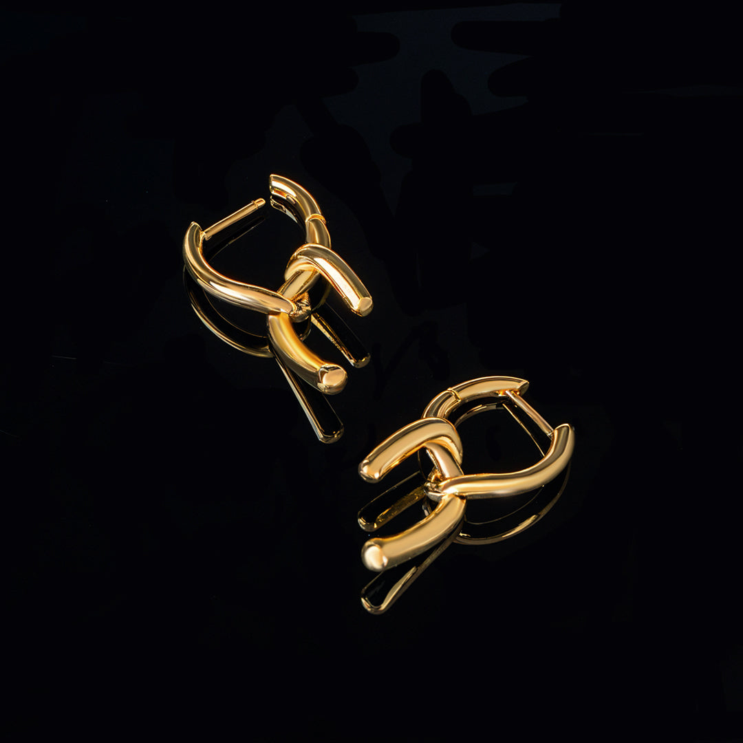 Pair of gold hoop earrings for women on a black background