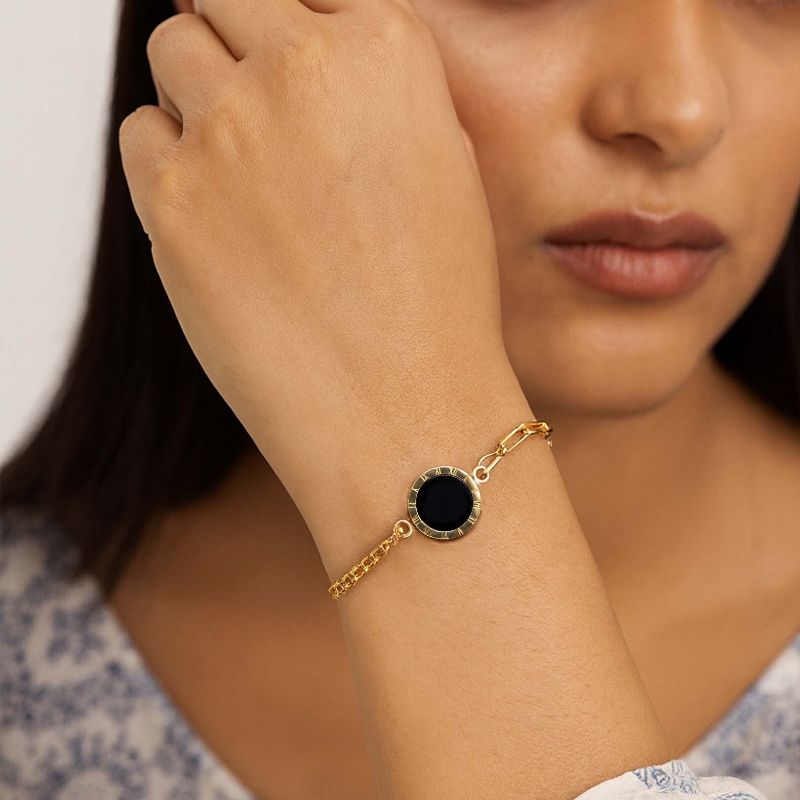 Gold bracelet with a black stone