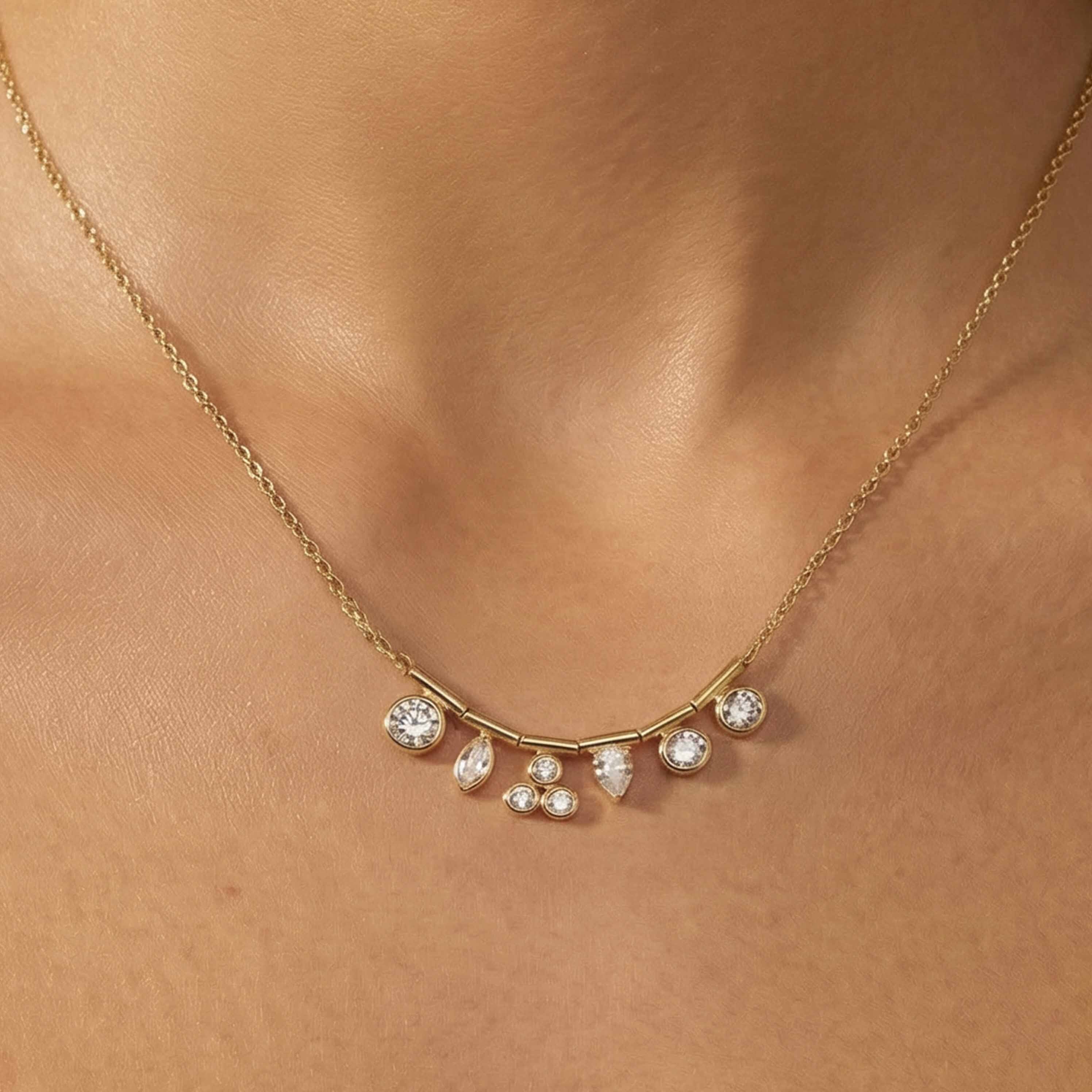 Gold necklace with small diamonds on a person's neck