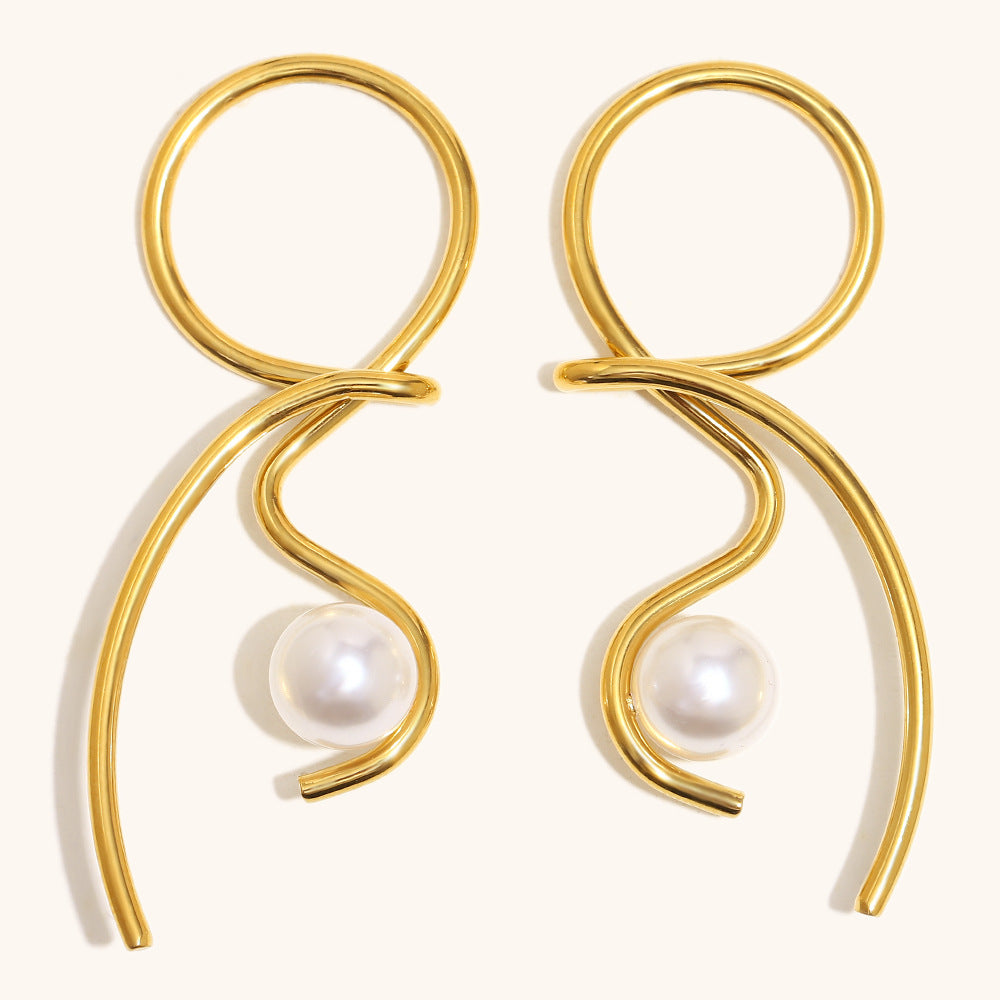 Gold earrings for women  with pearl beads on a white background